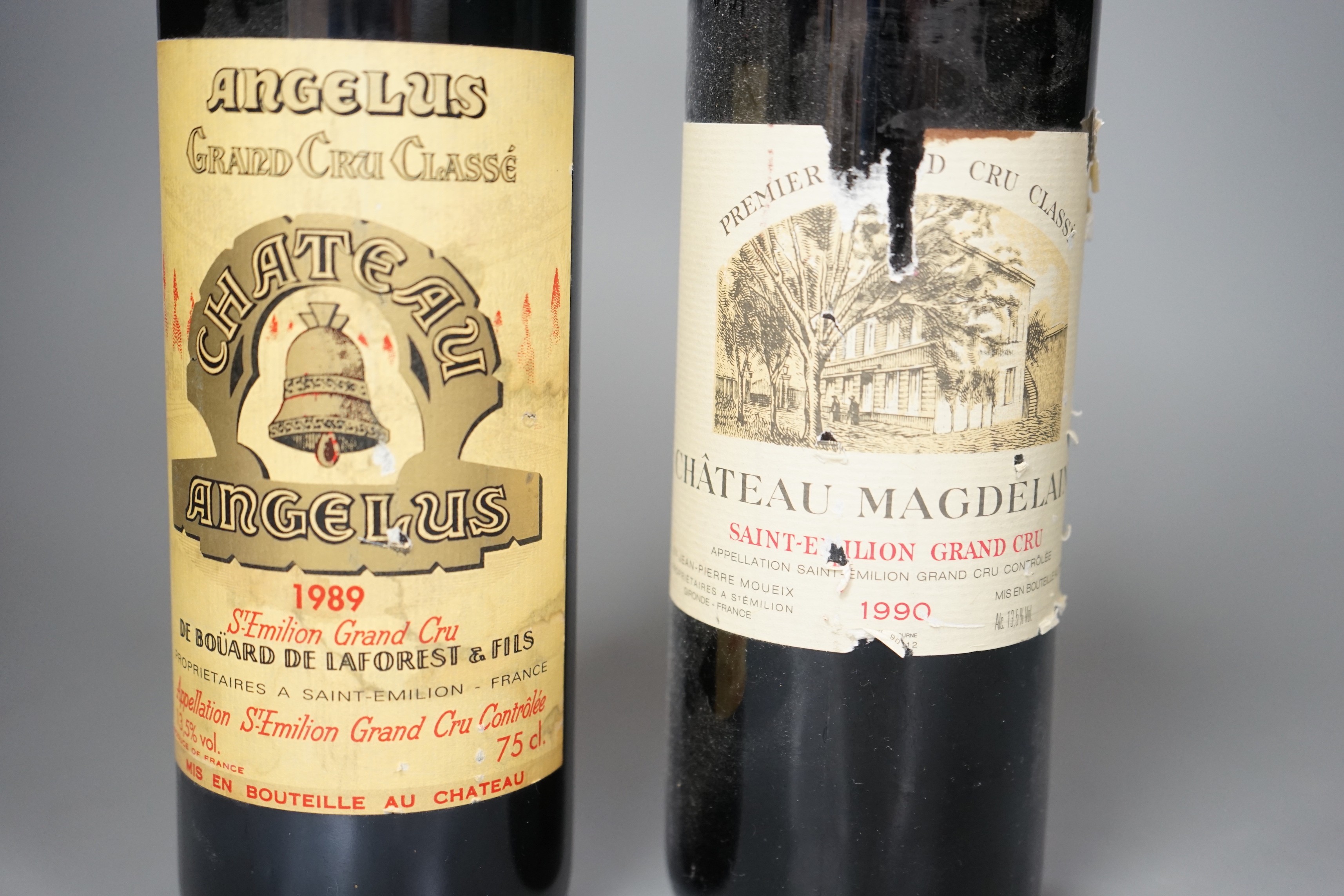 Two bottles of wine: Chateau Magdelaine St. Emilion Grand Cru 1990 and Chateau Angelus St Emilion Grand Cru 1998